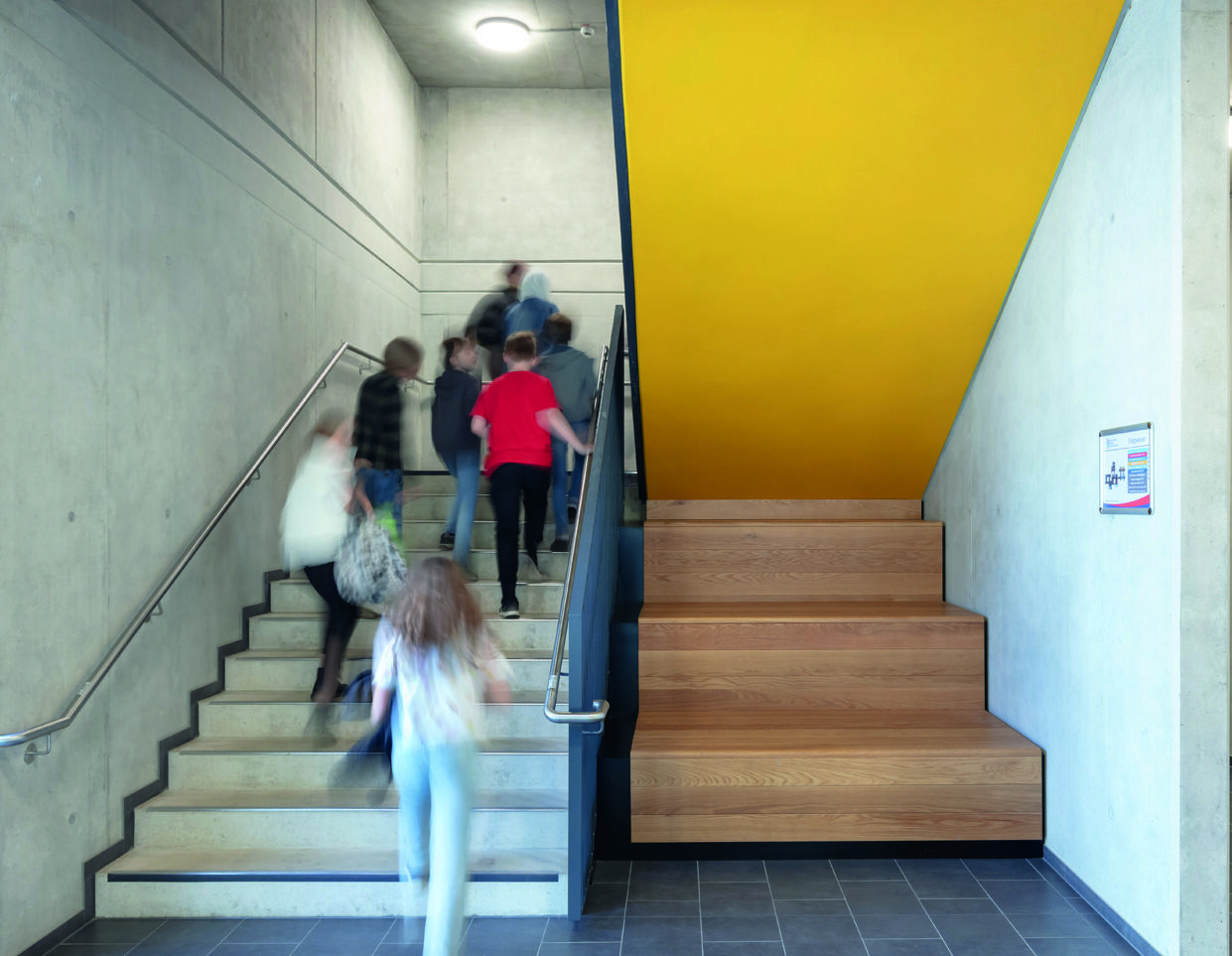 Helles Treppenhaus der Geschwister-Scholl-Gesamtschule Dortmund mit klarer Wegeführung und großzügigem Tageslichteinfall.